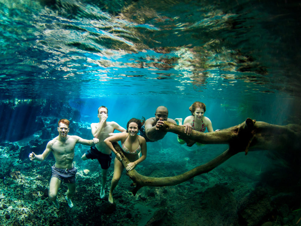 People posing for a photo under water